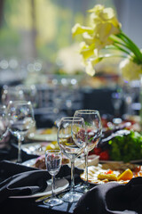 Beautifully set banquet table with black tablecloth. S