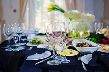 Beautifully set banquet table with black tablecloth. S