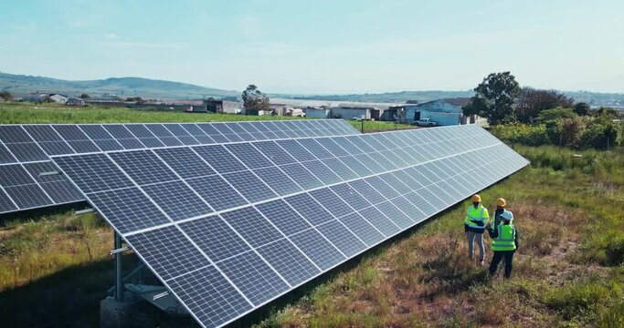 Drone of solar panels, engineering people and teamwork for renewable energy, electricity or eco friendly power solution. Industry group on farm, land or field with photovoltaic grid for planning