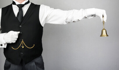 Portrait of Butler or Waiter in White Gloves Holding Gold Bell. Concept of Ring for Service....