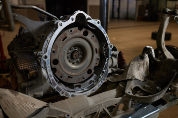 Closeup disassembled car automatic transmission gear part on workbench at garage or repair factory...