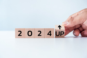 Wooden blocks with new year 2024, arrow up icons on white background, Business development and...