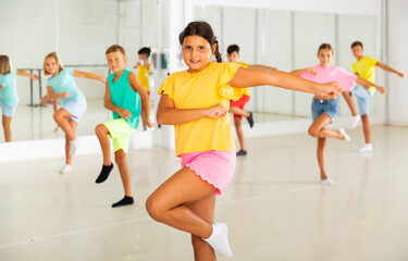Fototapeta premium Active children dancing modern dances in a choreographic studio