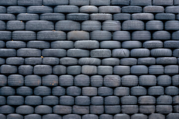Obraz premium obsolete car tires stacked for background, old and used, road safety concept