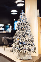 Beautiful decorated Christmas tree in room interior