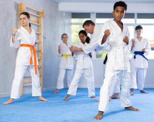 Group of karate kids practicing karate technique in gym.. © JackF