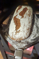 Fresh home-baked dark bread from the wood-burning stove fresh on a bread slider