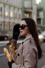 person in a city with baguette