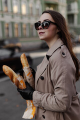 person in a city with baguette