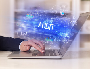 Closeup of businessman hands working on laptop