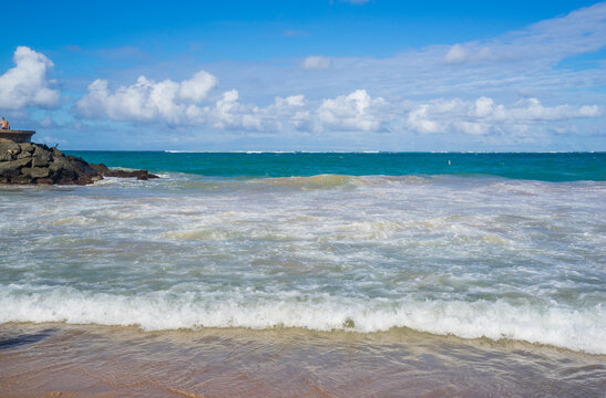 Background of beautiful wave on rocky and sandy beaches. Condado beach in San Juan, Puerto Rico. A commercial area that attracts tourists for tropical weather