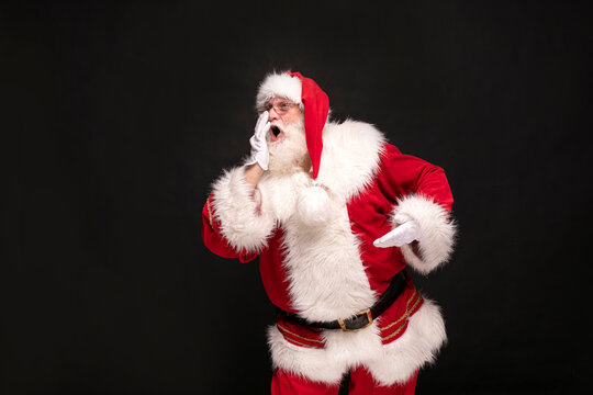 Real Santa Claus screaming on studio background.