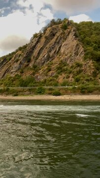 Traveling along the Rhine River with views of the medieval landscape of St. Goarshausen, Germany and the Lorelei slate rock. Located within the Rhine Gorge (Middle Rhine).