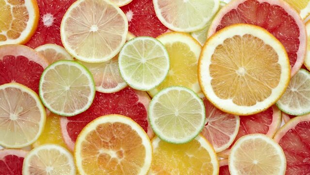 Slice of citrus fruit underwater or in water with splashing and droplet top view flat lay on white background.