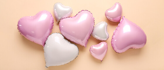 Heart-shaped balloons on beige background, top view. Valentine's Day celebration