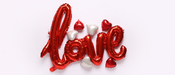 Balloons in shape of word LOVE and hearts on light background. Valentine's Day celebration