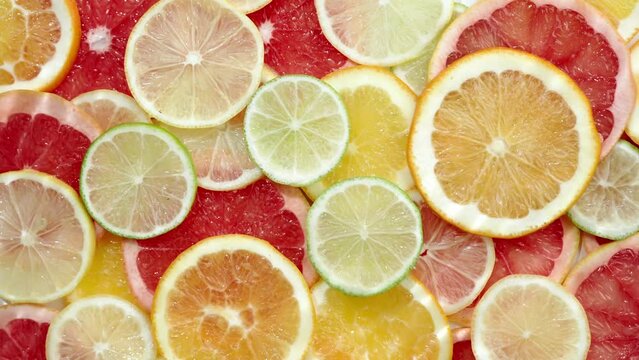 Slice of citrus fruit underwater or in water with splashing and droplet top view flat lay on white background.