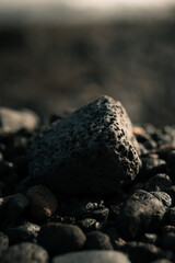 Black volcanic rock, porous stone on a beach