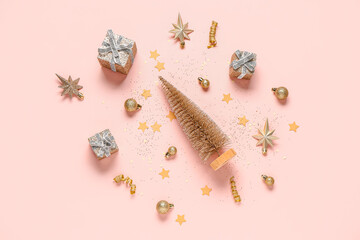 Christmas composition with golden decorations, confetti and gift boxes on pink background