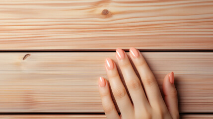 Elegant hand rests on a pine wood surface, fingernails polished in the trendy Peach Fuzz 2024 shade, reflecting natural simplicity. - obrazy, fototapety, plakaty