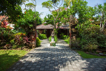 Traditional Balinese style gardens and buildings in a hotel in Bali, Indonesia.