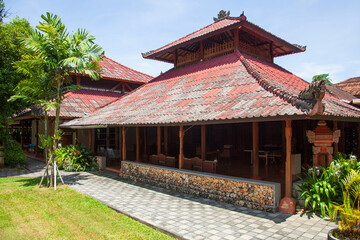 Traditional Balinese style gardens and buildings in a hotel in Bali, Indonesia.