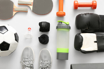 Composition with different sports equipment on light background