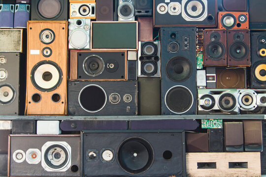 Vintage speaker wall. Antique speakers stacked in various ways sits ready to play loud music for a crowd of people.  