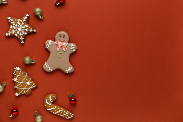 Gingerbread cookies with Christmas tree balls on brown background