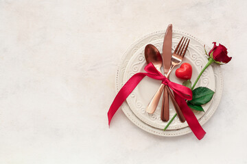 Beautiful table setting with red rose and heart on white background. Valentine's Day celebration