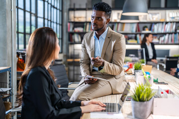 Group of creative business meeting and discussing strategy startup project analysis finance process.Success asian business people work plan and brainstorm marketing idea with laptop in office.Teamwork