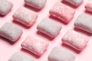 Tasty colorful bubble gums on pink background, closeup