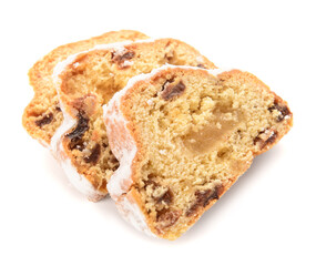 Slices of tasty Christmas stollen on white background