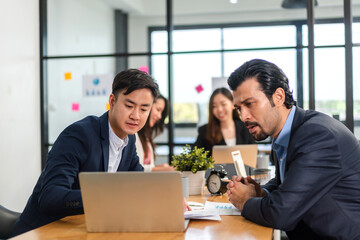 Fototapeta premium Group of creative asian business meeting and discussing strategy startup project analysis finance process.Success asian business work plan and brainstorm marketing idea with laptop in office.Teamwork.
