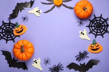 Obraz na płótnie Canvas Frame made of bats, pumpkins, ghosts and spiders on purple background, space for text. Halloween celebration