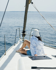 a woman on the bow of yacht