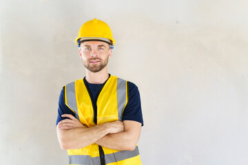 Portrait of smart and good looking caucasian white male foreman or construction contractor smiles to camera.