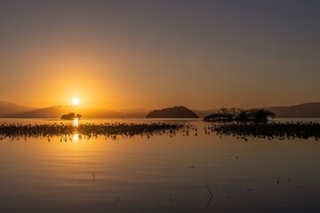 Fototapeta na wymiar 夕焼けに染まる冬の琵琶湖の情景