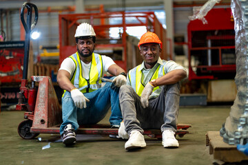 Portrait of African American technician engineer workers team inside the manufacturing factory line...