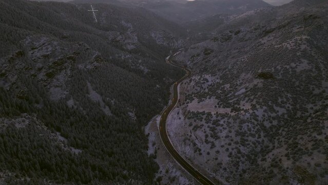 Colorado Christmas first snow frosted Mount Lindo memorial golden sunset Christian Catholic Jesus Cross hope and faith 285 highway Morrison Conifer Evergreen aerial cinematic drone pan up forward