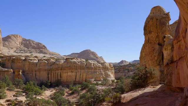 Establishing shot of mountain trail with red rocks in Hickman Natural Bridge Trail, Capital Reef National Park, Utah, North America. ProRes 422 HQ.