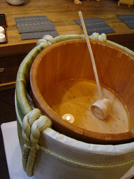 Japanese Celebration concept with half empty Opened Komo-daru Japanese traditional sake barrel with wooden scoop
