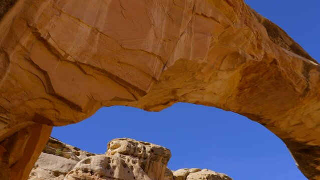 Establishing shot of mountain trail with red rocks in Hickman Natural Bridge Trail, Capital Reef National Park, Utah, North America. ProRes 422 HQ.