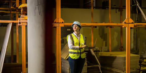 Hispanic woman in work clothes working at a construction site