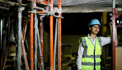 Hispanic woman in work clothes working at a construction site
