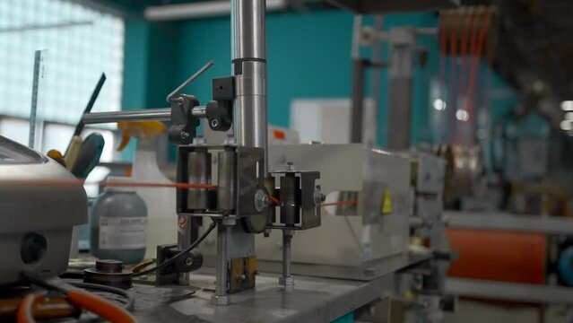 Rotating reels with copper wires on them. Creative. Metal wire spool spinning on the machine.