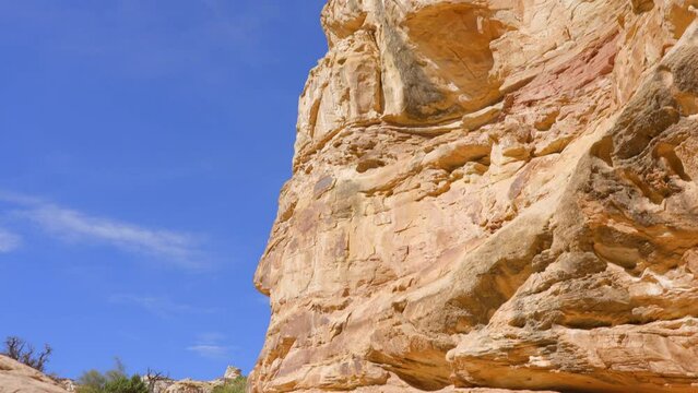 Establishing shot of mountain trail with red rocks in Hickman Natural Bridge Trail, Capital Reef National Park, Utah, North America. ProRes 422 HQ.