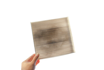 Car air conditioner filter isolated , filter clogged and dirty in a hand on white background...