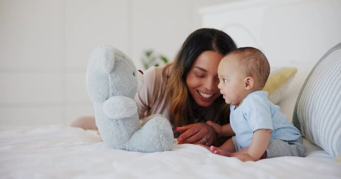 Happy, mom and baby with teddy bear in bed playing, bonding and fun together in morning. Infant, smile and mother with love, care and support for child in bedroom, home or house with toys and games