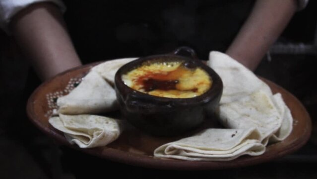 Melted cheese with chorizo, in a grilled meats restaurant. Traditional Mexican food concept.